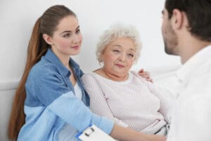 Granddaughter visiting grandmother in assisted care facility to ensure they are meeting expectations.